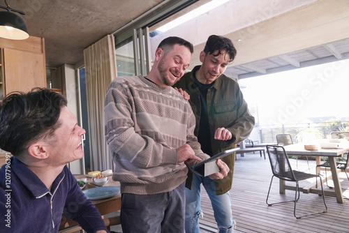 Smiling men looking at digital tablet photo