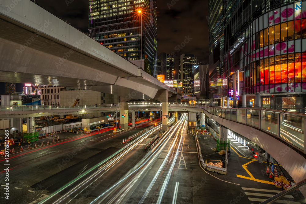 View of buildings and trail lights around Shibuya Station area at night, Shibuya District, Kamiyamacho, Shibuya City, Tokyo, Honshu, Japan View of buildings and trail lights around Shibuya Station area at night, Shibuya District, Kamiyamacho, Shibuya City, Tokyo, Honshu, Japan