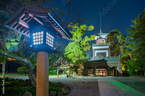 View of Oyama Shrine Shinmon Gate illuminated at dusk, Kanazawa City, Ishikawa Prefecture, Honshu, Japan