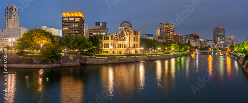 View of the skeletal ruins of the A-Bomb Dome from Hiroshima Peace Gardens at dusk, UNESCO, Hiroshima, Honshu, Japan