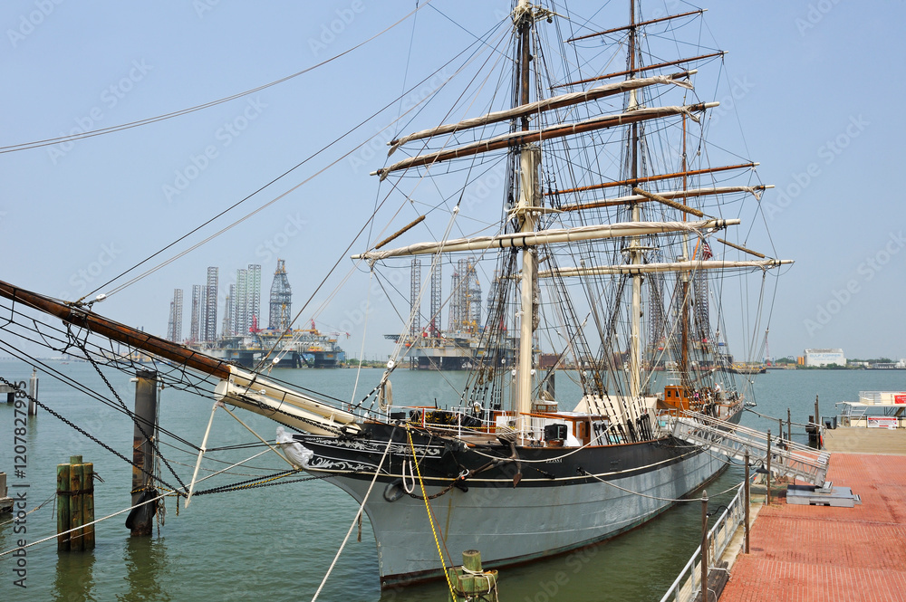 Tall ship Elissa, 1877, three-masted barque moored in port of Galveston at sunset, Galveston island, Gulf of Mexico, Texas, United States of America Tall ship Elissa, 1877, three-masted barque moored in port of Galveston at sunset, Galveston island, Gulf of Mexico, Texas, United States of America