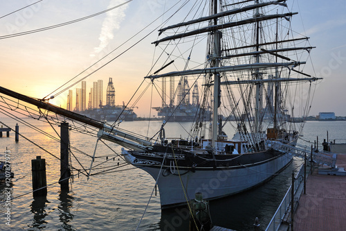 Tall ship Elissa, 1877, three-masted barque moored in port of Galveston at sunset, Galveston island, Gulf of Mexico, Texas, United States of America photo