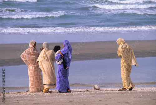 Women dressed in saris on the beach of Barka, Sultanate of Oman, Arabian Peninsula photo