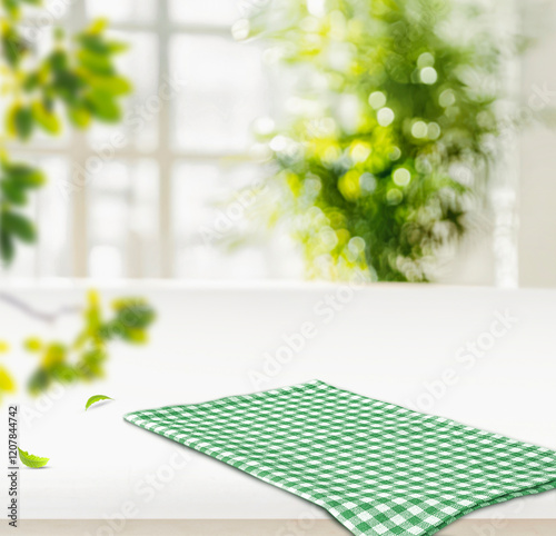 Green and white checkered tablecloth on a white kitchen counter with a blurred natural background. Perfect for food styling, dining themes, and cozy kitchen aesthetics photo