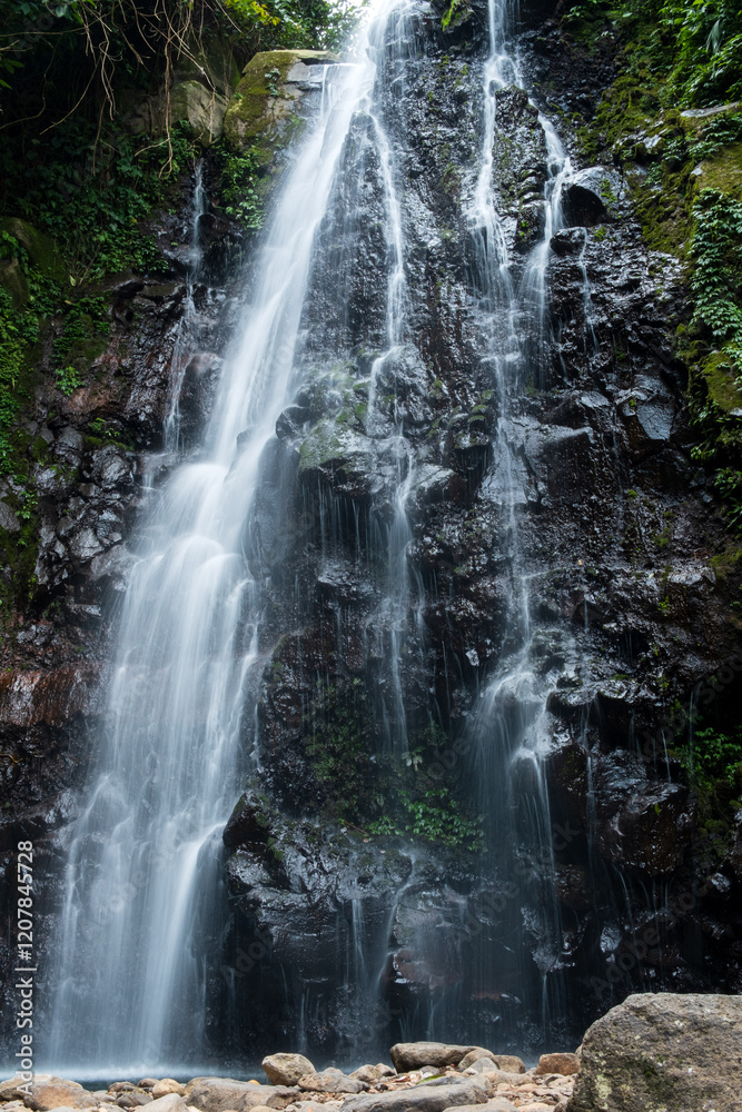 Powerful Waterfall Flowing Over Rocky Cliffs Powerful Waterfall Flowing Over Rocky Cliffs