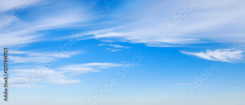 Vast blue sky with wispy cloud trails, dreamy atmosphere