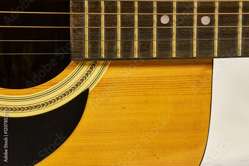 Modern style wooden acoustic guitar isolated, showing some specific parts, with metal strings, ideal for Rock music