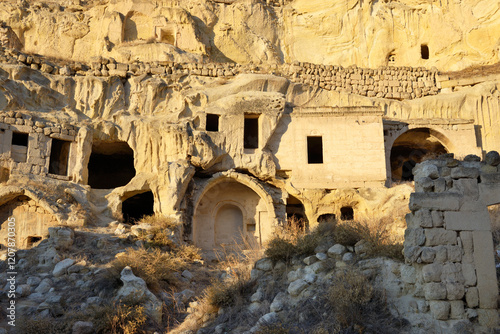 Part of cliff dwelling complex of ancient Christian churches and houses in village of Cavusin near Goreme, Cappadocia, Turkey