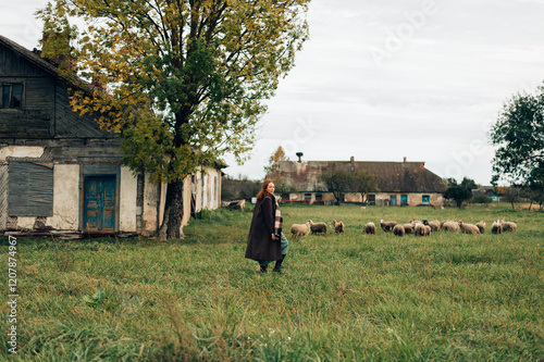 Girl in a coat with sheep