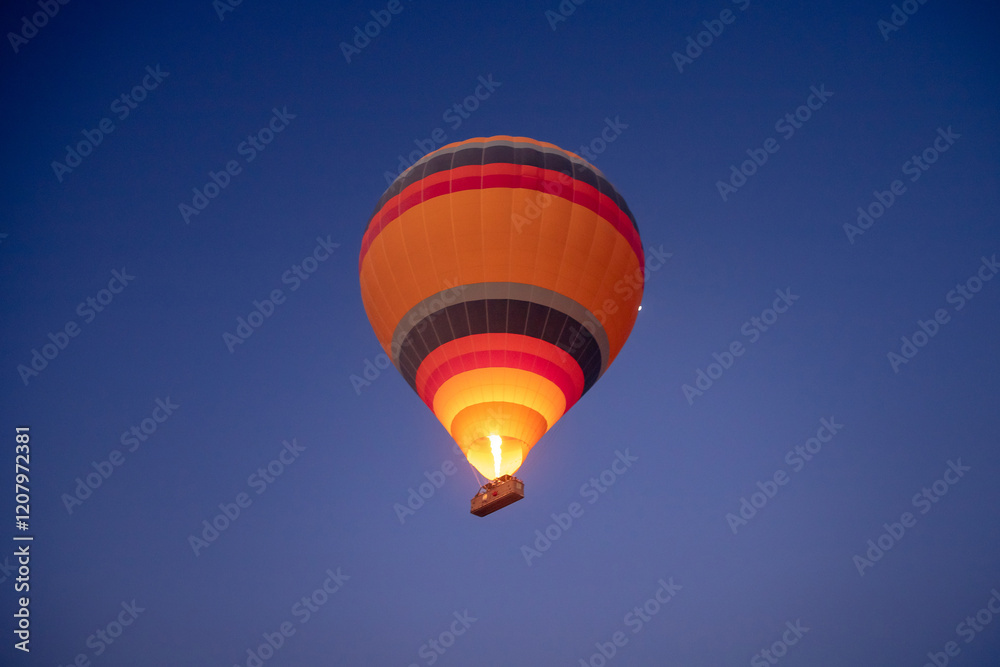 Naklejka premium Amazing aerial view of a beautiful hot air balloon over Cappadocia at dawn