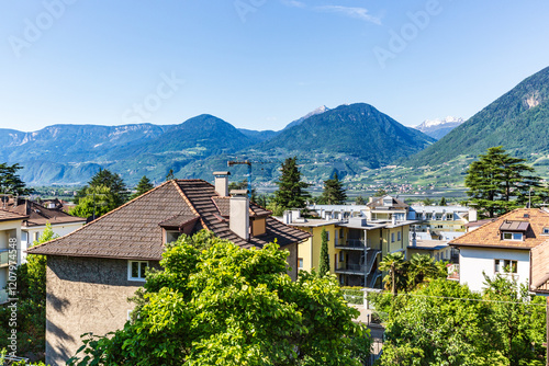 Picturesque Alpine Village Surrounded by Lush Greenery and Majestic Mountain Views