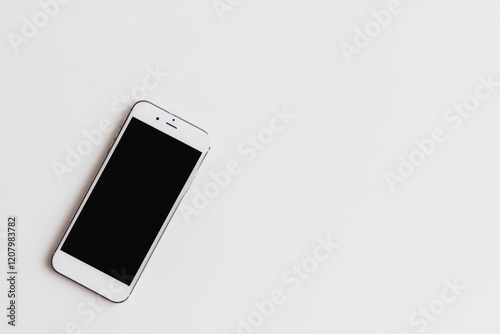 A modern smartphone with a black screen and minimal bezels placed flat on a solid white background, single object photo