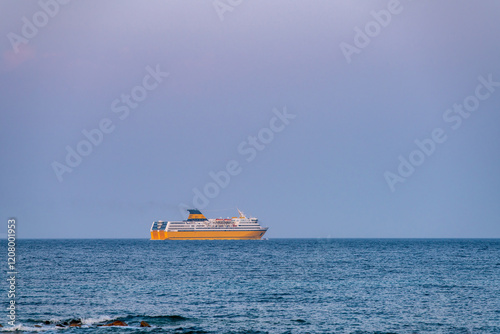 Ferry boat cruising on the mediterranean sea of Sardinia at sunset