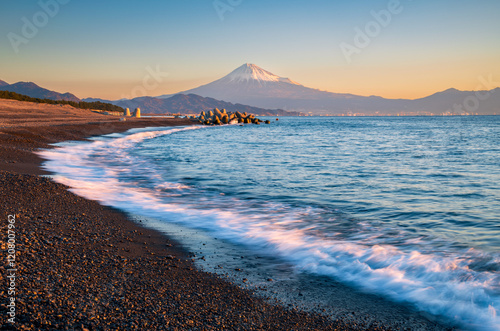 Mountain Fuji with wave crushing beach at sunrise view from Suruga Bay, Shizuoka, Japan