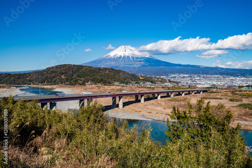 Car passing bridge with Mount Fuji in background, Shizuoka, Japan photo