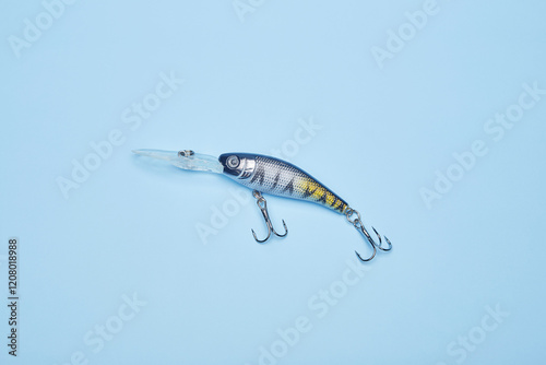 Fishing bait wobbler jig isolated on the bright blue fond background photo