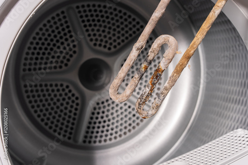 Obraz na płótnie Close-Up of a Corroded Heating Element Covered with Limescale Deposits Inside a Dryer Drum w salonie