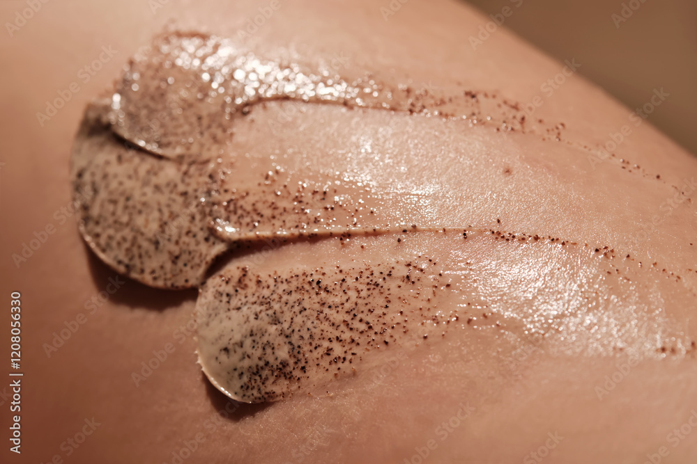 Fototapeta premium Coffee cream scrub on human skin close-up.