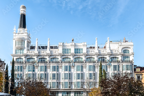 Front view of ME Madrid Reina Victoria Hotel located at Plaza de Santa Ana in Madrid featuring its elegant white facade and architectural details. Madrid, Spain - November 30, 2021