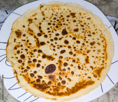 A French crepe on a plate. Zenital view