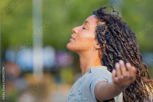 portrait of beautiful young latina woman breathing relaxed outdoors