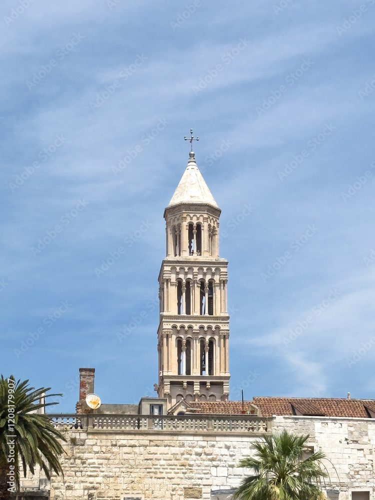 Split, Croatia - July 1, 2024: Coastal boardwalk. Saint Domnius Cathedral tower peeks over historic Diocletian's Palace walls. Split, Croatia - July 1, 2024: Coastal boardwalk. Saint Domnius Cathedral tower peeks over historic Diocletian's Palace walls.