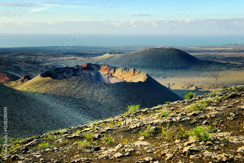 Obraz na płótnie Volcano cones and lava fields. Timanfaya National Park, Lanzarote, Canary Islands. North from Camino Pista Rural de los Valcenes w salonie