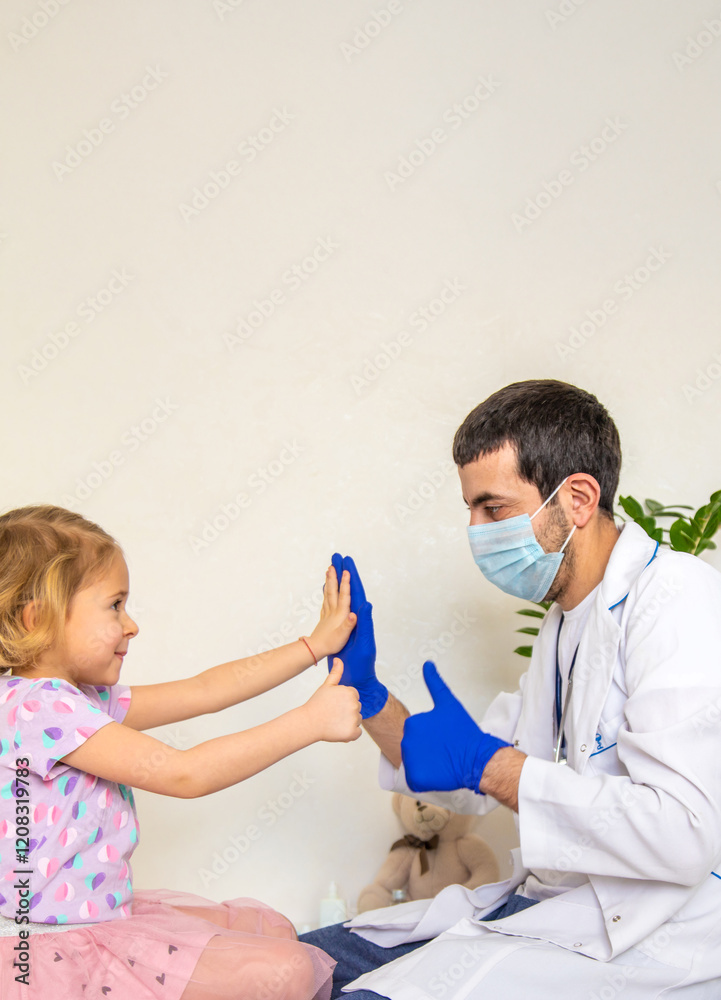 Fototapeta premium A child is being treated by a doctor in a clinic. Selective focus.