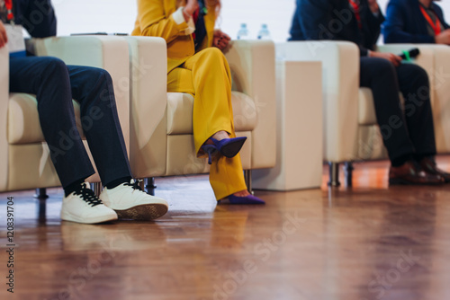 Speakers shoes legs at the business conference event, audience on forum summit, plenary session lecture hall, persons on a stage at plenary meeting, business congress at the venue, panel discussion