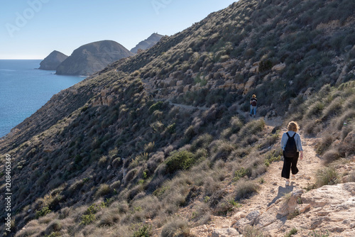 Tourists walking along the cliffs of the Cabo de Gata-Níjar Maritime-Terrestrial Natural Park, Almeria
