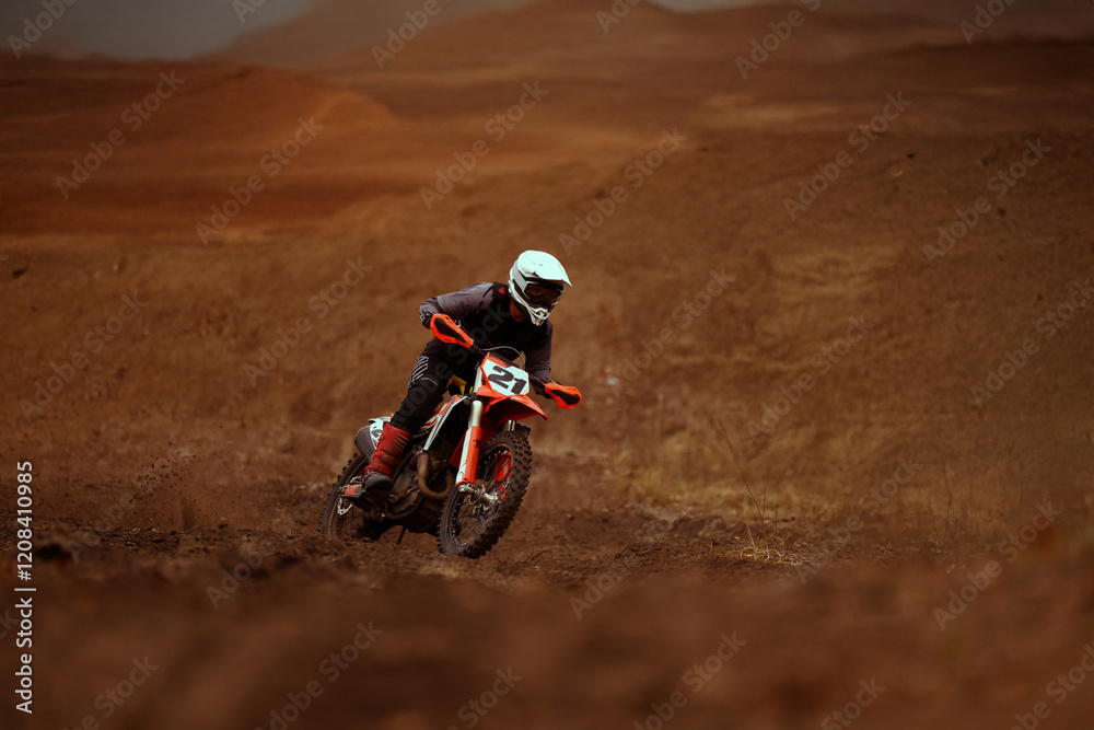 Motocross racer rides through the desert. Motocross racer rides through the desert.