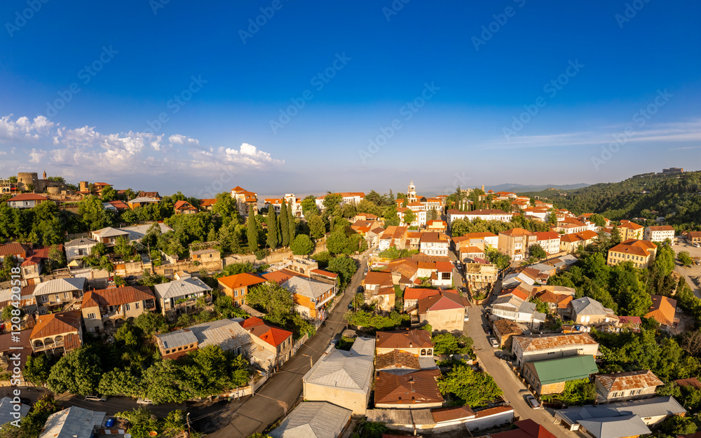 Fototapeta premium Aerial view on St. George's Church and Alazani valley, Georgia, Kakheti region, Signagi village. Sighnaghi city of love on hill near Gombori Range. Drone Photography in sunny summer day.
