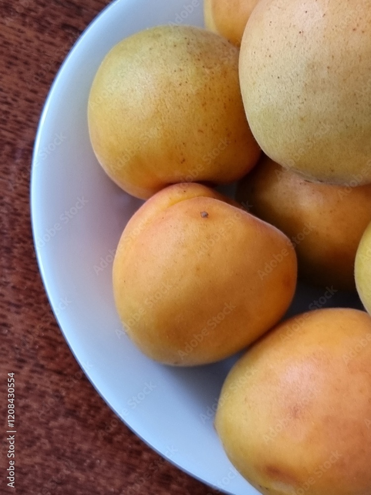 fresh yellow apricots on a wooden background fresh yellow apricots on a wooden background