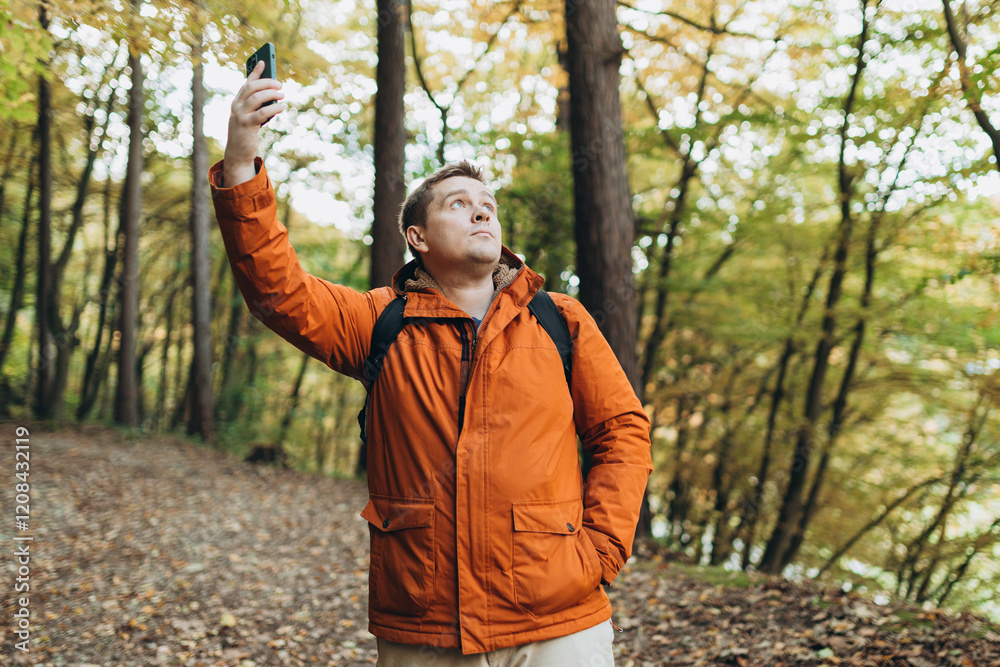 No communication coverage, lost contact signal device. Sad blonde man got lost and could not find an internet connection on phone while hiking alone in the forest.