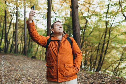 Obraz na płótnie No communication coverage, lost contact signal device. Sad blonde man got lost and could not find an internet connection on phone while hiking alone in the forest. w salonie