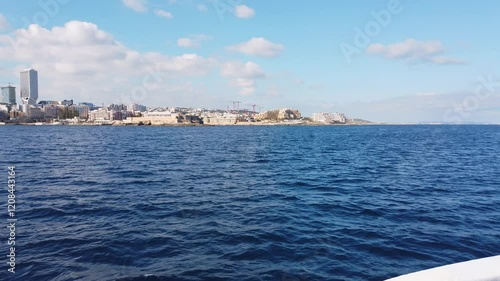 View of St Julian's, Malta, from a ferry on a sunny winter morning