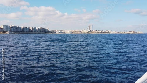 View of Sliema and St Julian's, Malta, from a ferry on a sunny winter morning