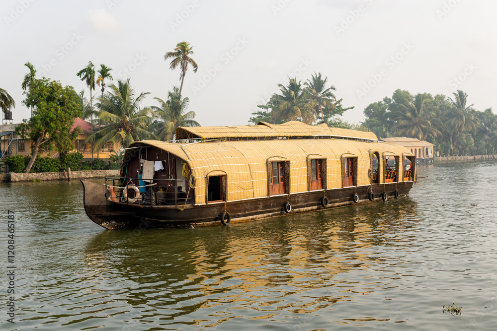 Traditional houseboat floating on the backwaters of Kerala, India Traditional houseboat floating on the backwaters of Kerala, India