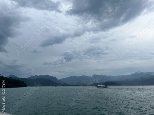 barco no mar com tempestade aproximando photo