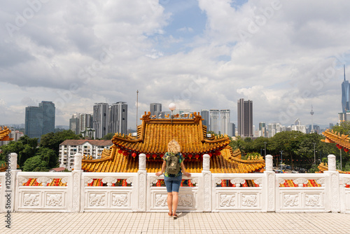 Photography Young blonde tourist woman enjoying the view of Kuala Lumpur downtown from Thean
