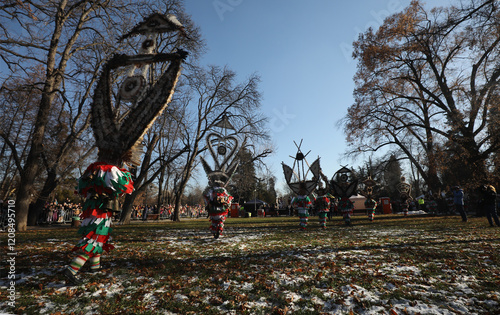 The Surva masquerade games festival in Sofia, Bulgaria. People called Kukeri parade in masks and ritual costumes, perform ritual dances to drive away evil spirits in Sofia, Bulgaria photo