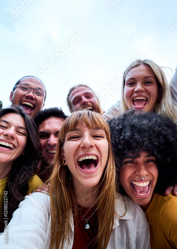 Fotografie Vertical selfie of group young multi-ethnic beautiful friends having fun together outdoors