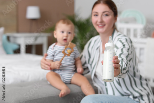 Mother with bottle of milk ...
