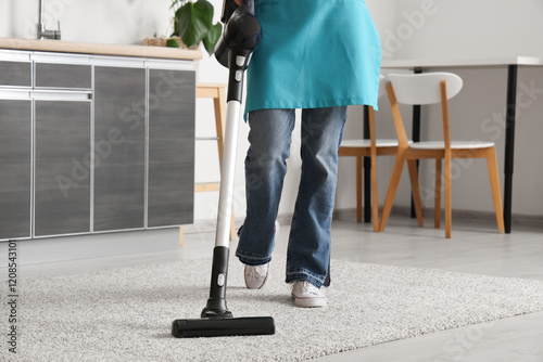 Young woman cleaning carpet...