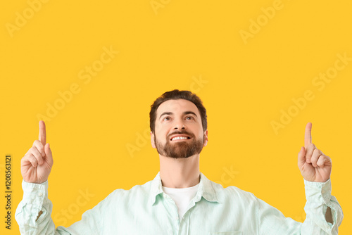 Handsome man pointing at so...