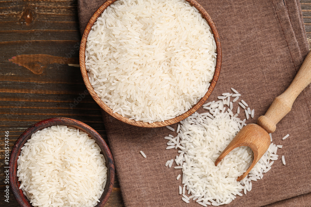 Bowls with raw rice and scoop on wooden background Bowls with raw rice and scoop on wooden background