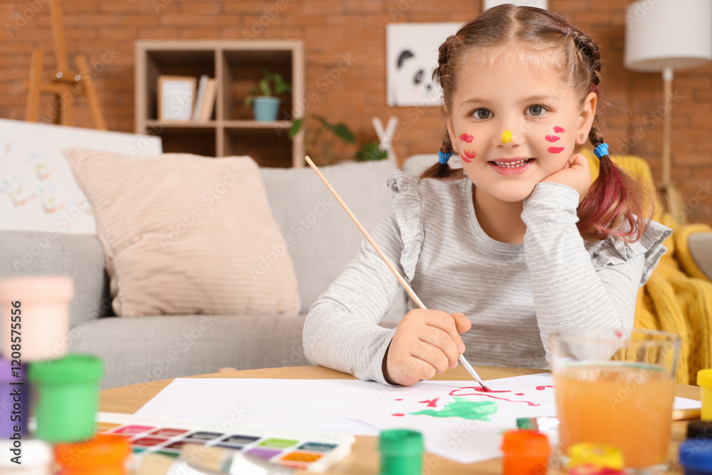 Little girl painting on table at home Little girl painting on table at home