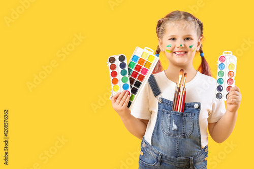 Little girl with paints on ...