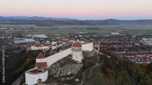 A closer aerial look at the intricate details of Râșnov Fortress, showcasing its walls, inner courtyards, and strategic hilltop vantage point.