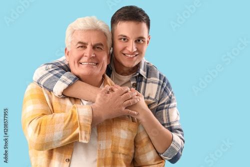 Young man hugging his fathe...
